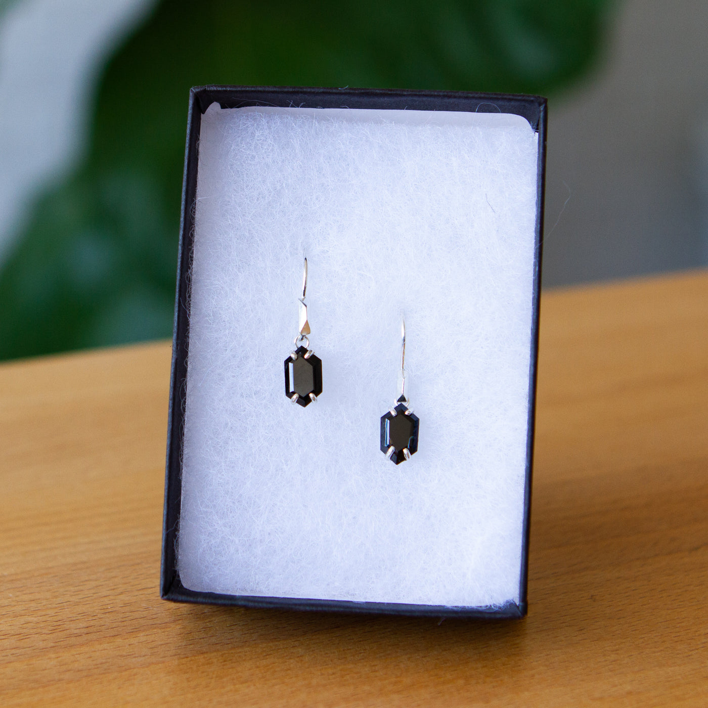 Eloise Black Garnet Earrings in Silver packaged in a jewelry box