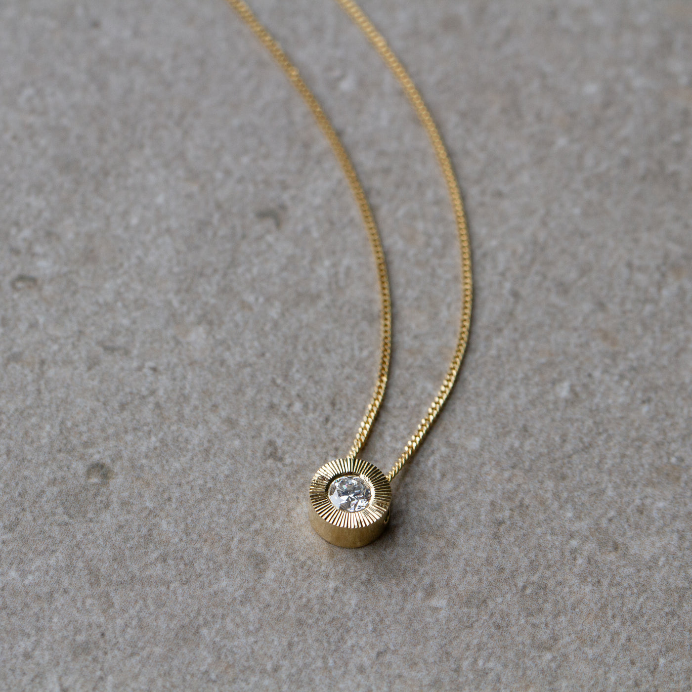 Old European Cut Diamond Medium Aurora Necklace In Yellow Gold on a neutral background, side angle