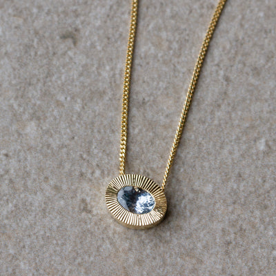 East-West Oval Aurora Necklace with Silver Montana Sapphire in Yellow Gold on a neutral background, front angle