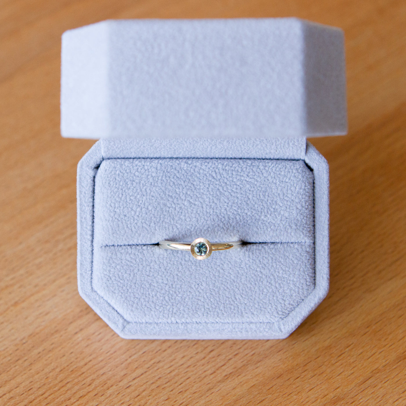 Teal Montana Sapphire Large Aurora Stacking Ring in Yellow Gold packaged in a gray ring box
