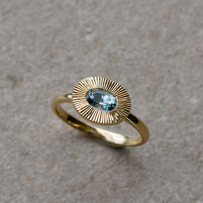 East-West Aurora Solitaire with Teal Oval Montana Sapphire on a neutral background, from the top
