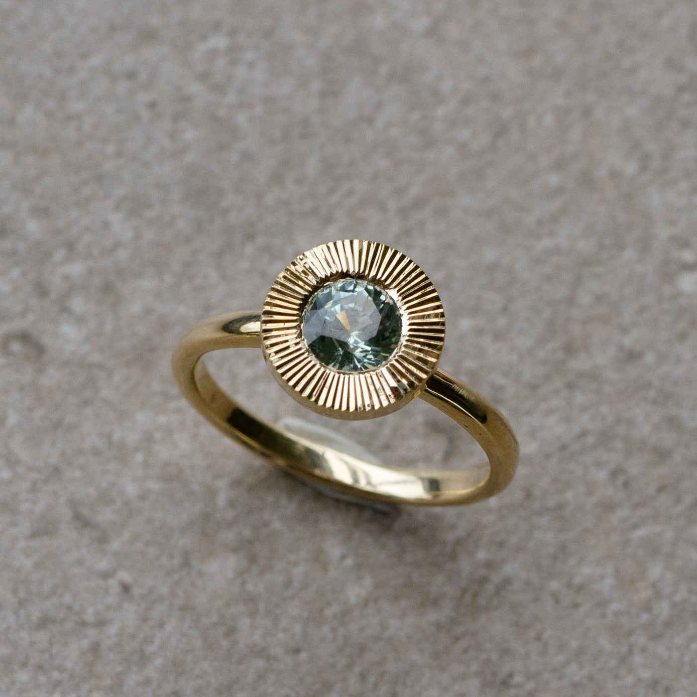 Green Montana Sapphire Aurora Solitaire .95ct on a neutral background, front angle