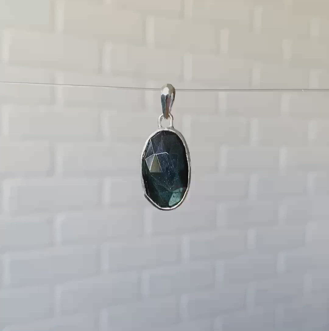 Large oval rose cut labradorite pendant crafted from sterling silver with a faceted silver bail