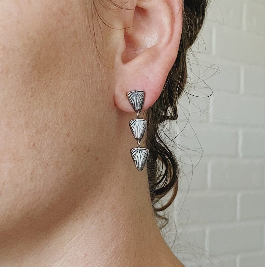 Oxidized Silver Flicker Earrings on an ear