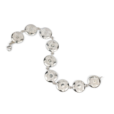 Sterling silver round sunburst link bracelet with diamond centers by Corey Egan on a white background