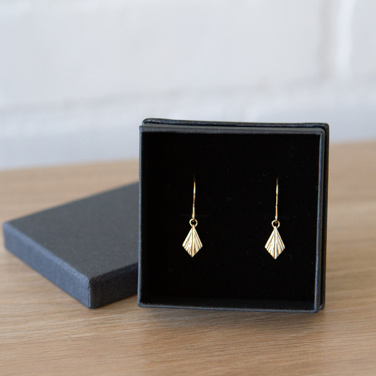 Gold Flame Earrings by Corey Egan in a gift box