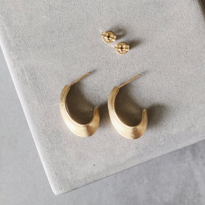 Sculptural Gold Textured Hoop Earrings on concrete