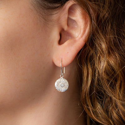 Large Lucia Silver Diamond Dangle Earrings on an ear