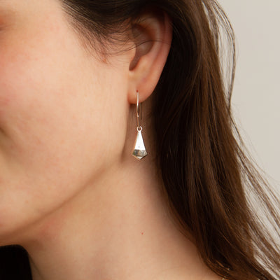 Silver Crystal Fragment Earrings modeled on an ear