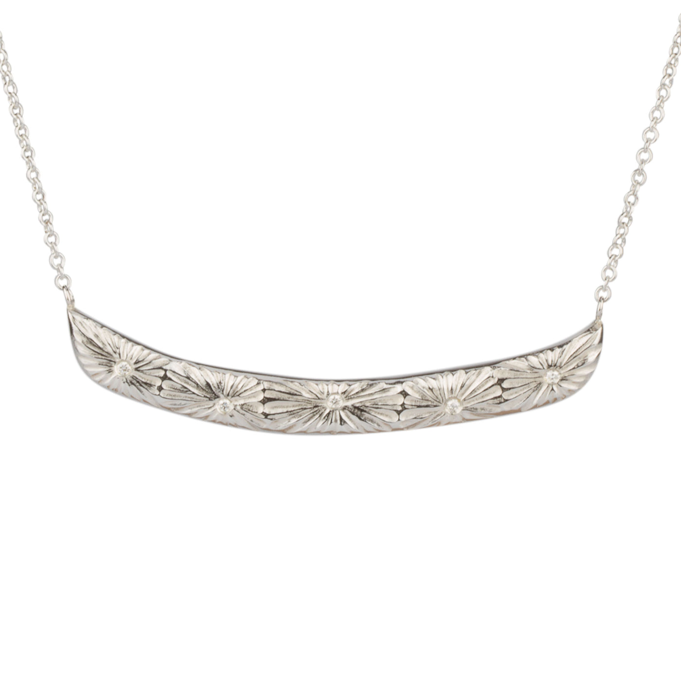 Sterling silver curved bar necklace with five scattered diamonds and an engraved sunburst pattern radiating from each on a white background | Corey Egan