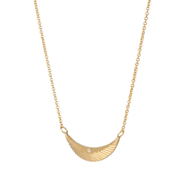 Side view of Crescent necklace with carved rays and a single diamond in vermeil  on a white background