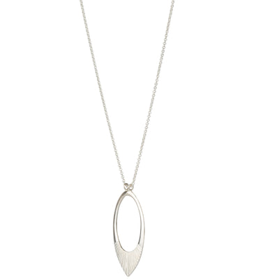 Side view of Extra long silver neckalce with large open petal shape pendant with carved ray texture across the bottom on a white background
