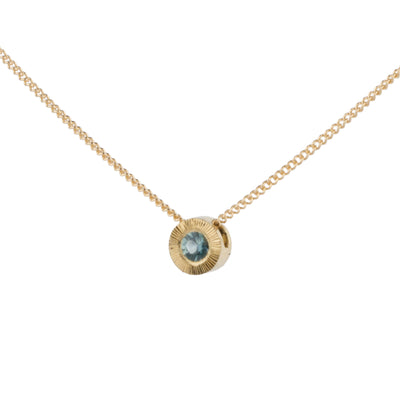 Side view 14k yellow gold small aurora necklace with a teal Montana sapphire center on a white background