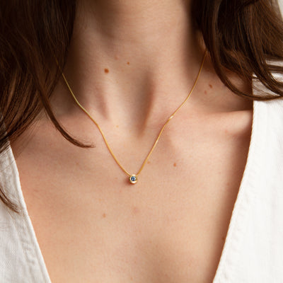 Blue Montana Sapphire Small Aurora Slide Necklace in Yellow Gold modeled on a neck