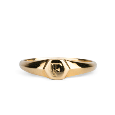 Low profile gold signet ring with hexagon top and engraved single block "F" initial