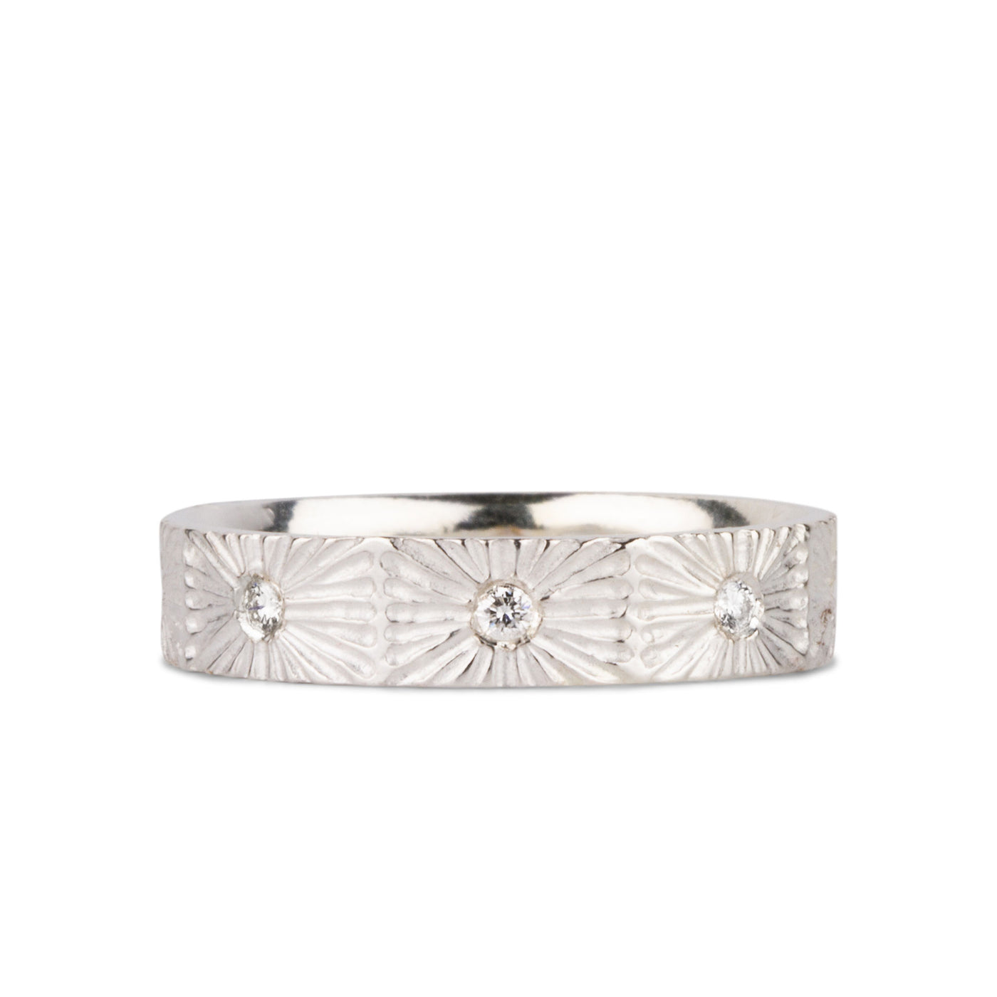Nova sunburst eternity band with 8 flush set diamonds and carved texture around the outside in sterling silver