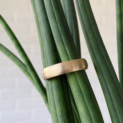 Wide half round Diablo brushed wedding band in yellow gold in natural light