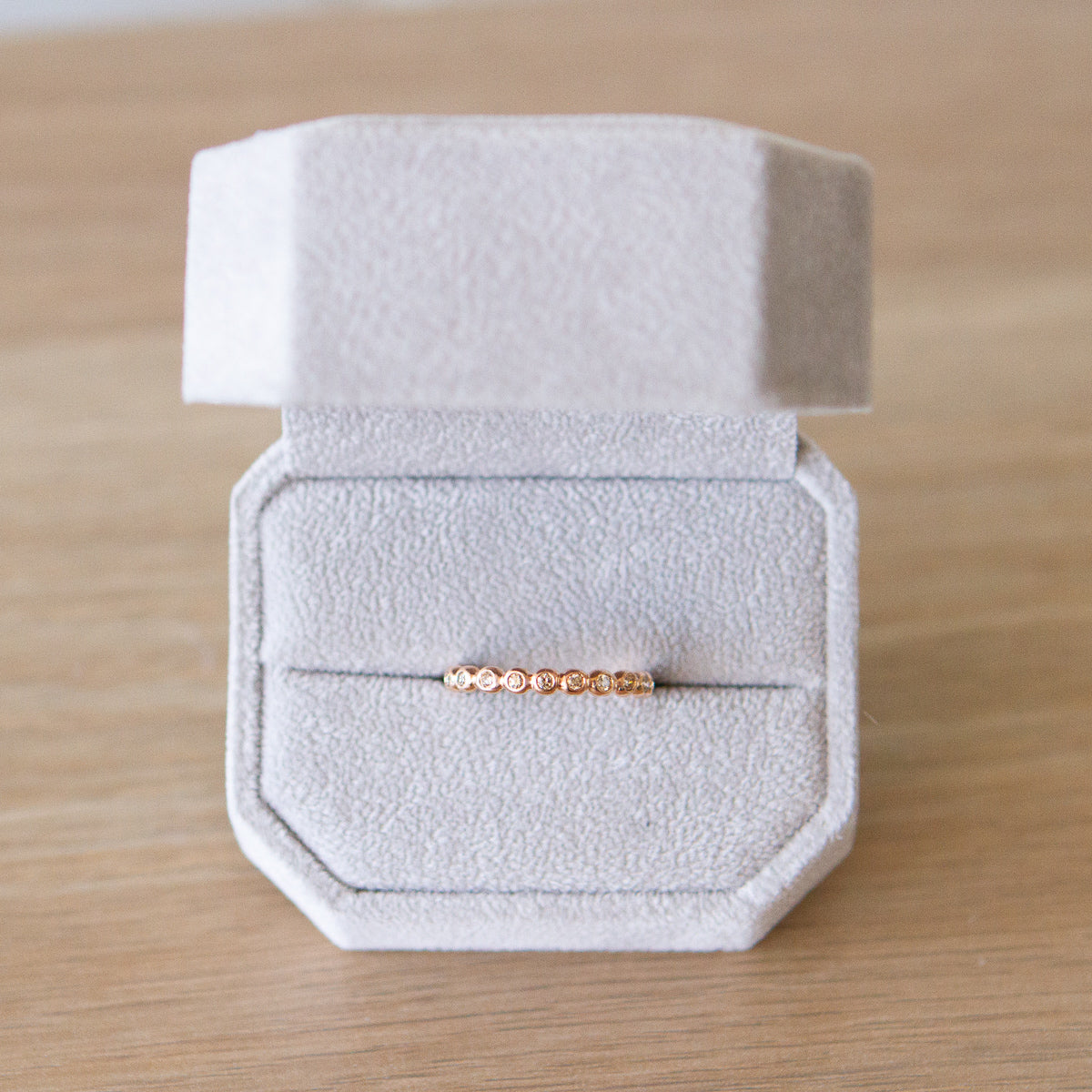 Champagne Diamond Droplet Band in Rose Gold by Corey Egan in a ring box