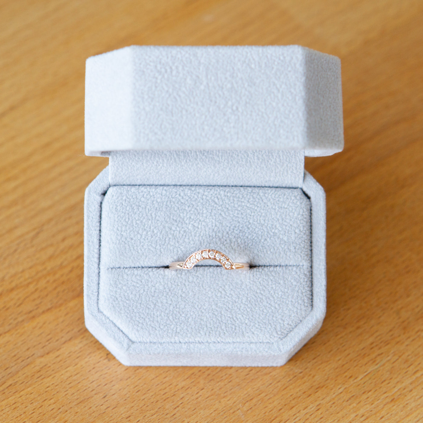 14k rose gold medium pave arch band with white diamonds in 14k rose gold in a ring box
