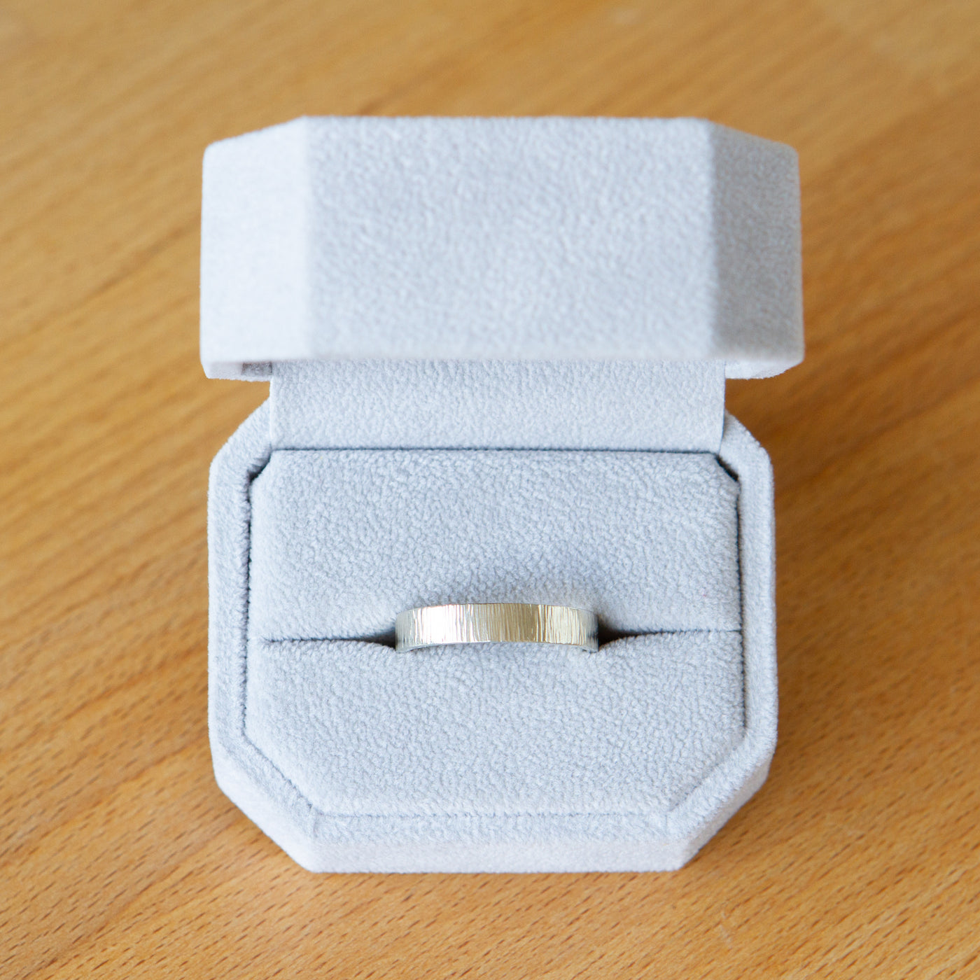 14k white gold Zion Band in a ring box by Corey Egan