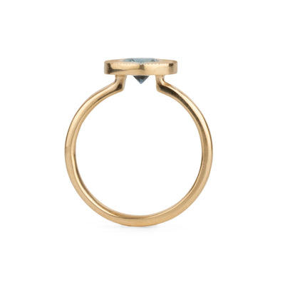 Profile view of Round mint green Montana sapphire in a 14k yellow gold Aurora ring with an engraved halo border on a white background