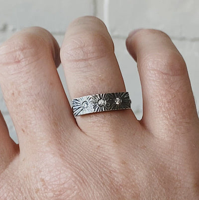 Nova Oxidized Silver and Diamond Ring by Corey Egan on a hand