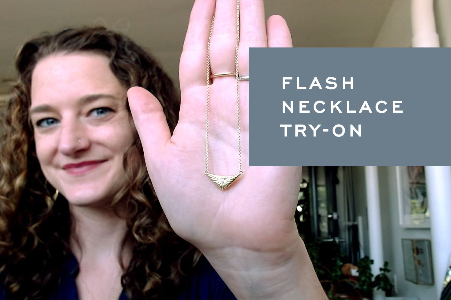Corey holds up the Flash Necklace in Gold