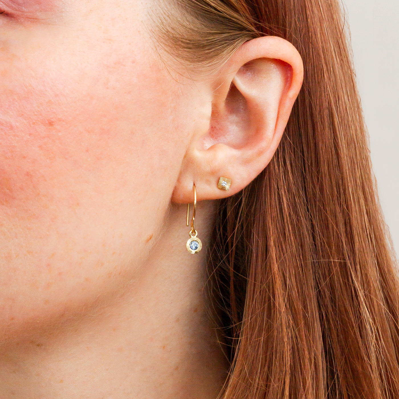 Blue Montana Sapphire Aurora Dangle Earrings in Yellow Gold on a model, close up