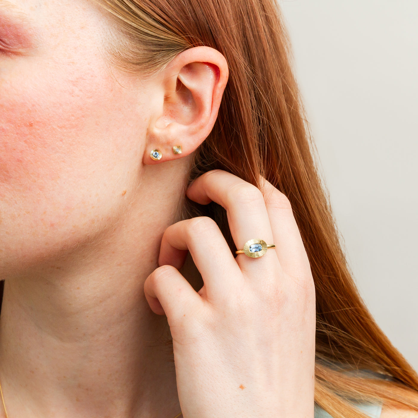 Large Aurora Blue Montana Sapphire Stud Earring in Yellow Gold on a model, wide angle