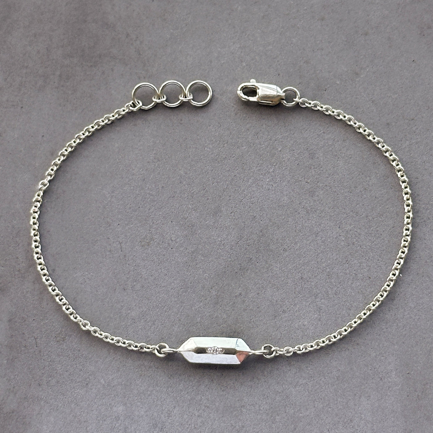 Fragment Chain Bracelet with Diamond in Silver on a gray neutral background