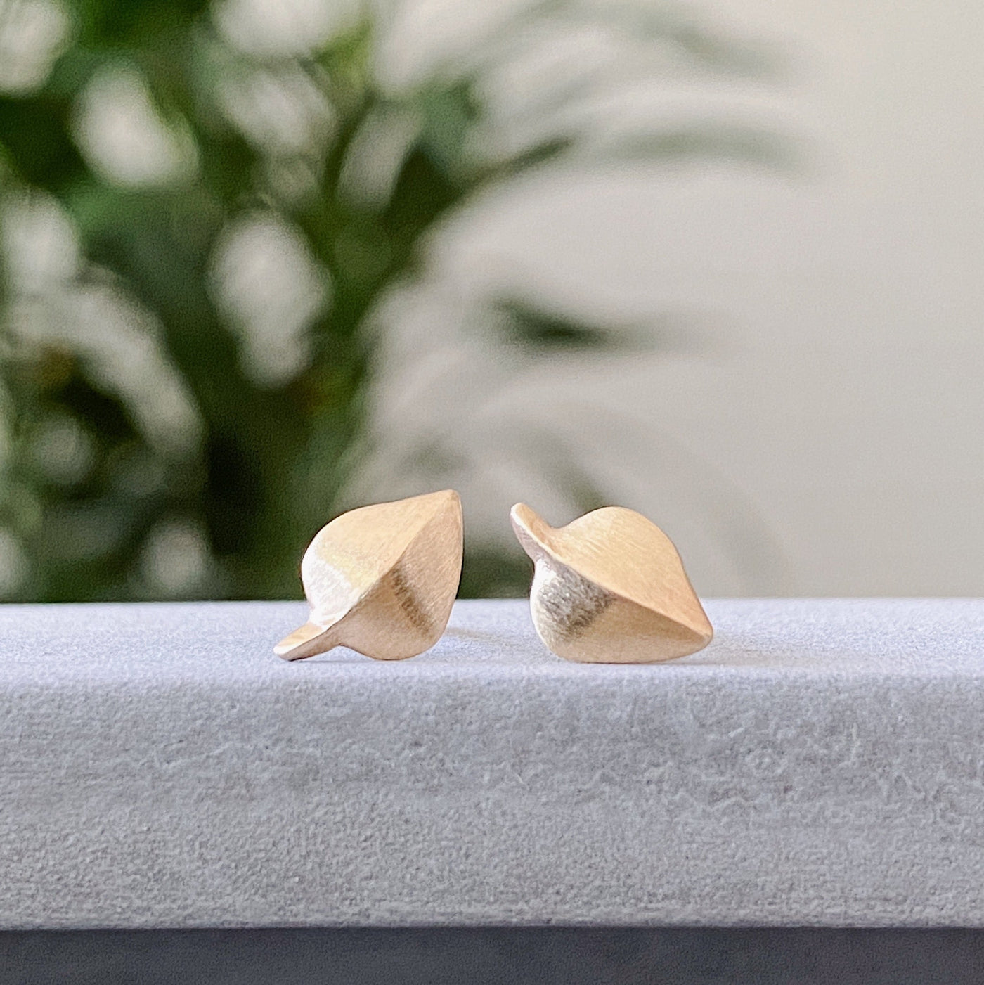 Yellow Gold Aspen Stud Earrings on concrete view #2 by Corey Egan