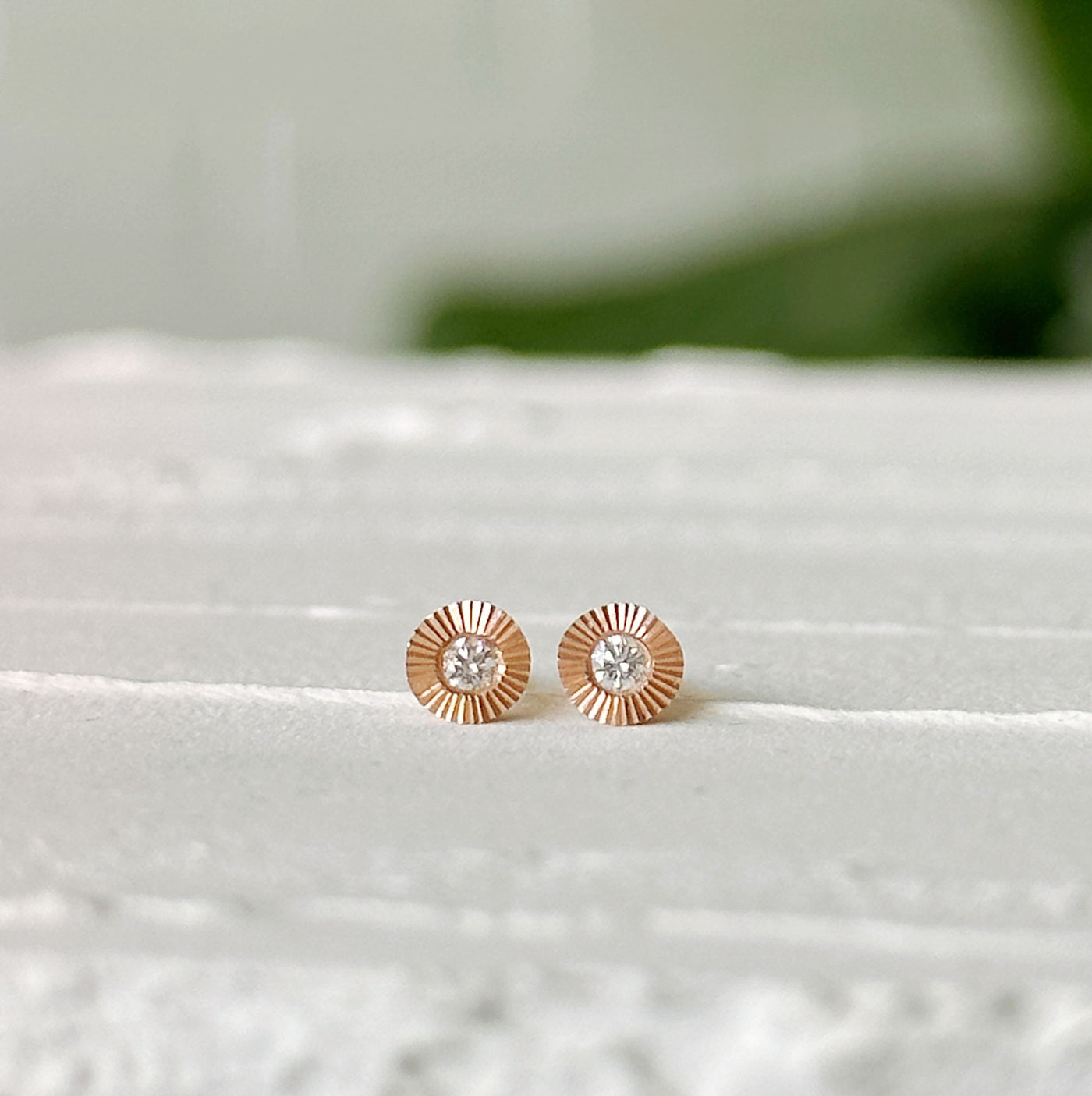 Small Aurora Diamond Stud Earring in Rose Gold sitting on a white table, front view