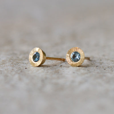 Large Aurora Teal Montana Sapphire Stud Earring in Yellow Gold on a neutral background, side angle