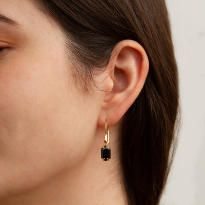 Eloise Black Garnet Earrings in Vermeil modeled on an ear