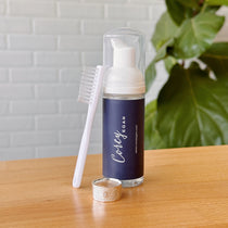 Foaming Jewelry Cleaner on a wooden table in front of a white wall
