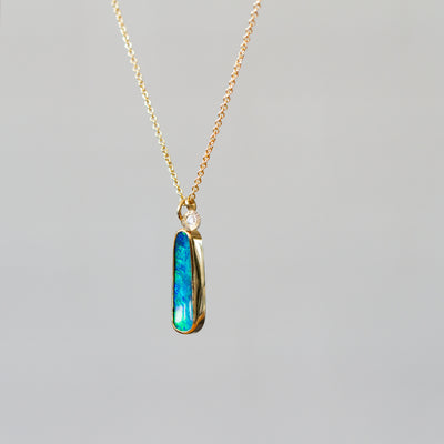 Australian Opal Gold Theia Necklace on a plain background, side angle