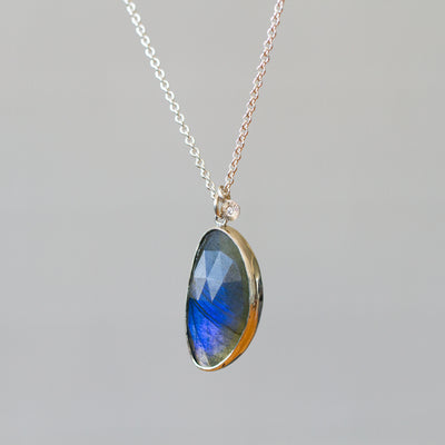 Labradorite Silver Theia Necklace #16 hanging in front of a plain background, side angle