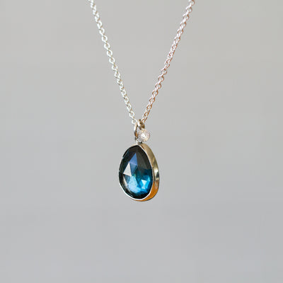 London Blue Topaz Silver Theia Necklace #11 in front of a plain background, side facing