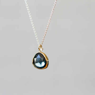 London Blue Topaz Silver and Gold Theia Necklace #9 on a plain background, side angle