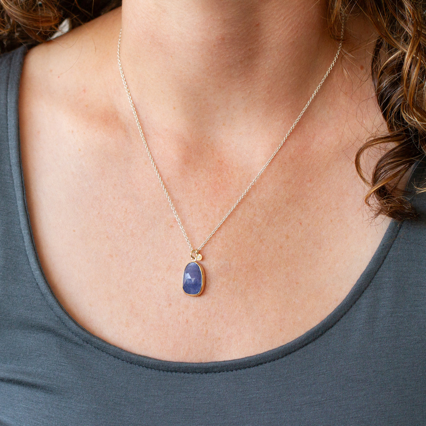 Tanzanite Silver and Gold Theia Necklace modeled on a neck