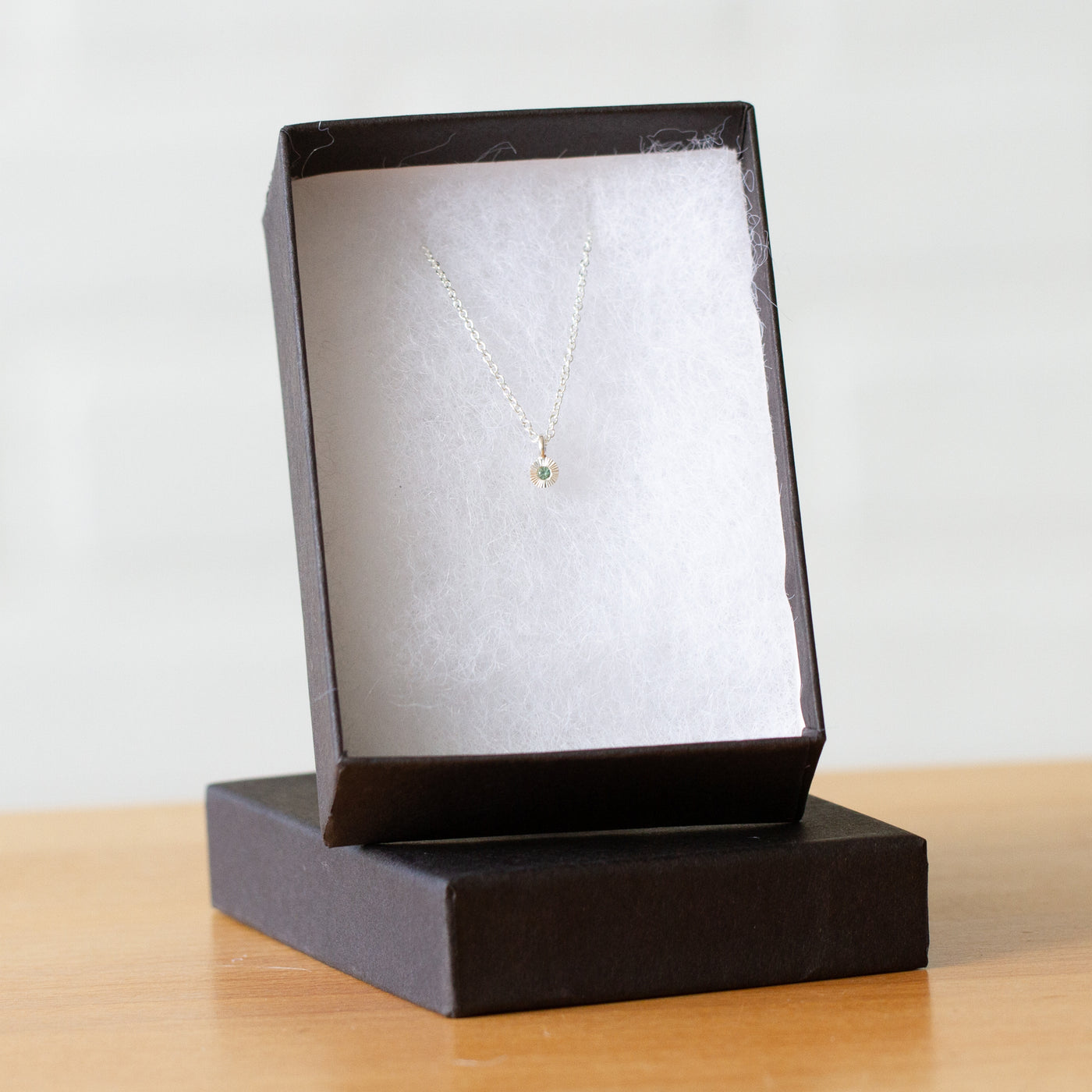 Green Sapphire Rise Necklace in Sterling Silver packaged in a jewelry box
