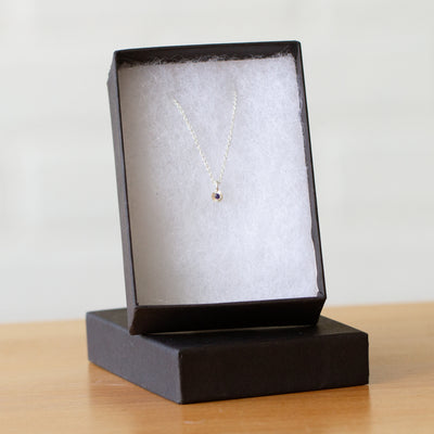 Purple Sapphire Rise Necklace in Sterling Silver packaged in a jewelry box