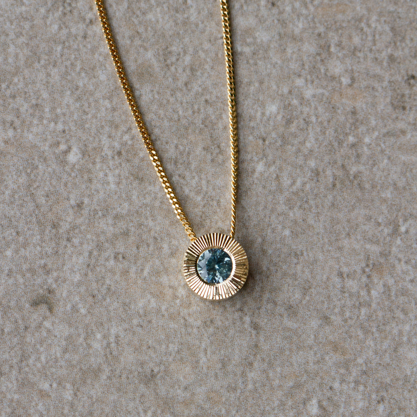 Light Green Montana Sapphire Medium Aurora Necklace in Yellow Gold on a neutral background, front angle