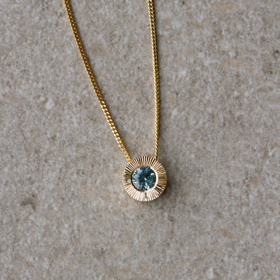 Light Green Montana Sapphire Medium Aurora Necklace in Yellow Gold on a neutral background, front angle