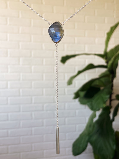 Rose Cut Labradorite Selene Lariat Necklace in Sterling Silver #2 hanging in front of a white wall, front angle