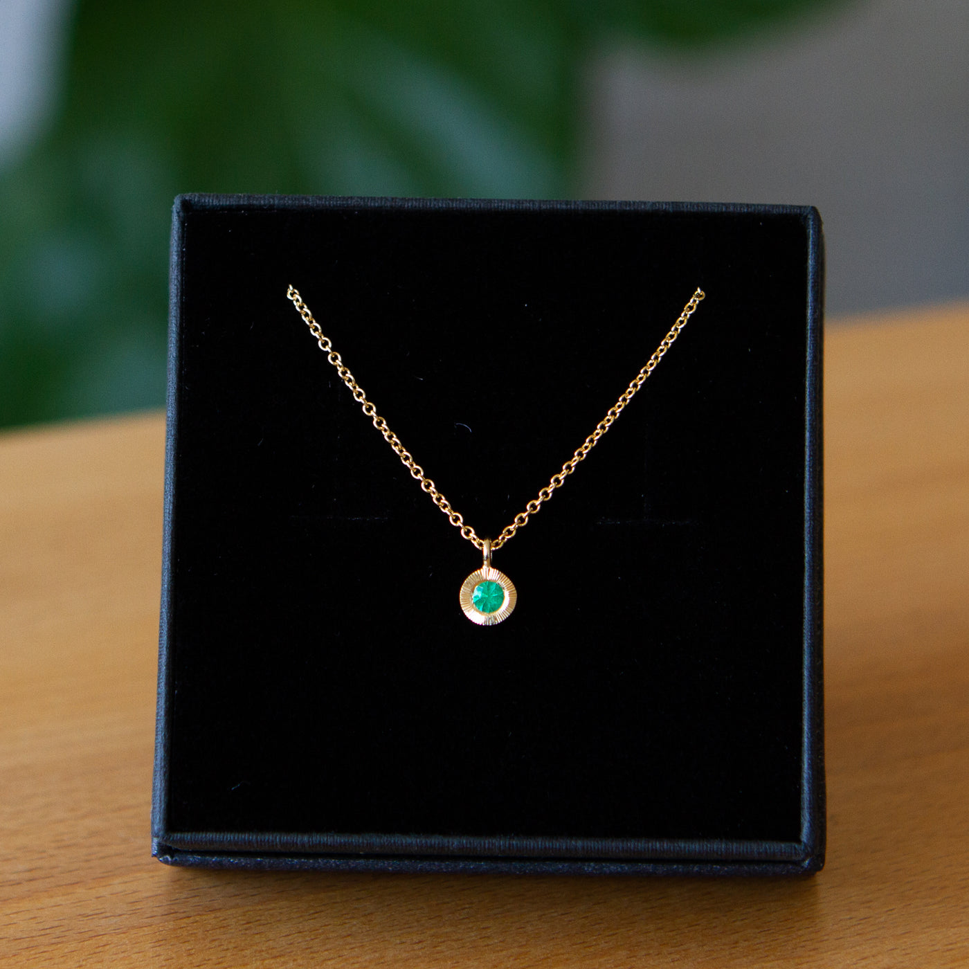 Emerald Small Aurora Pendant Necklace in Yellow Gold packaged in a black jewelry box