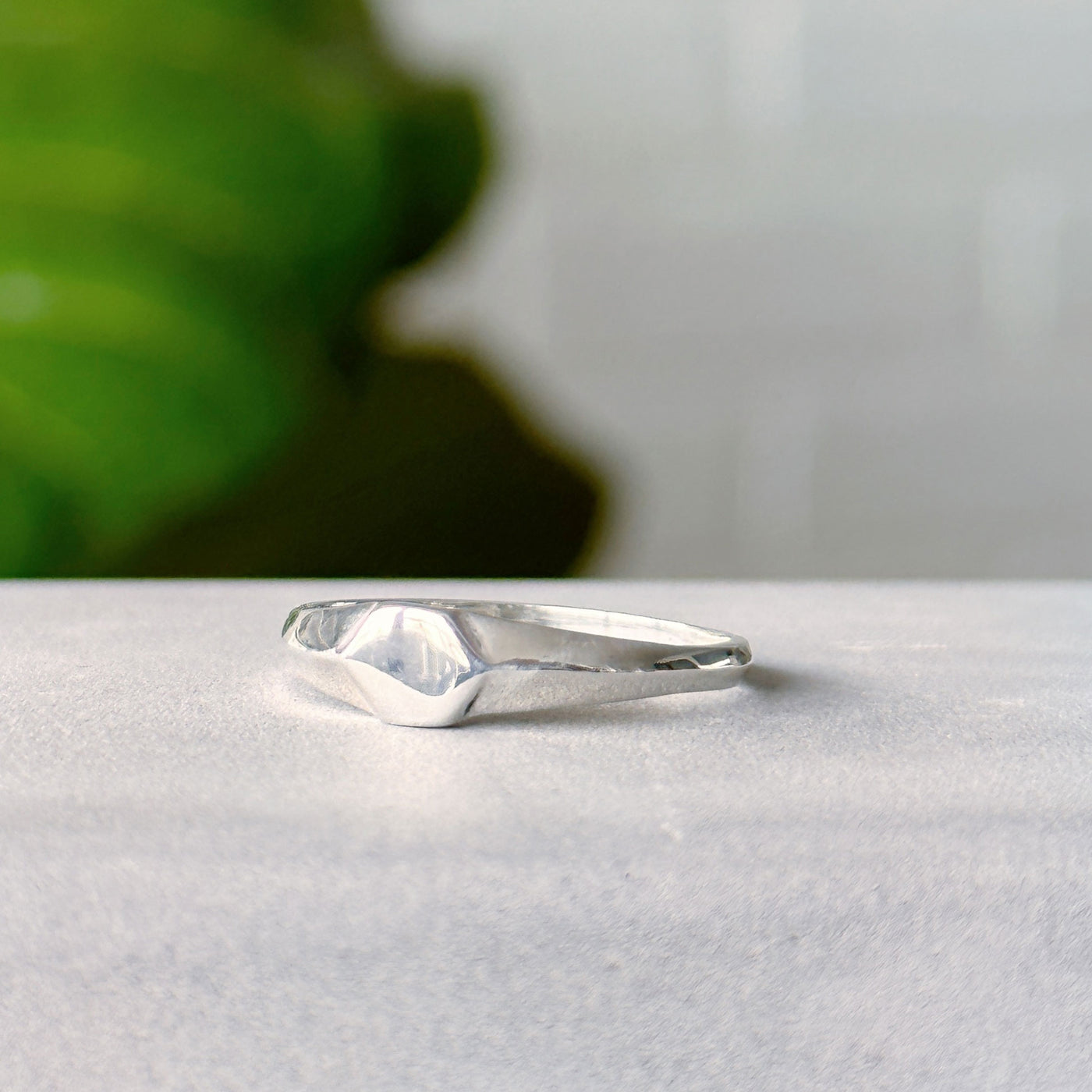 Astra Silver Signet Ring on a gray neutral background, side angle