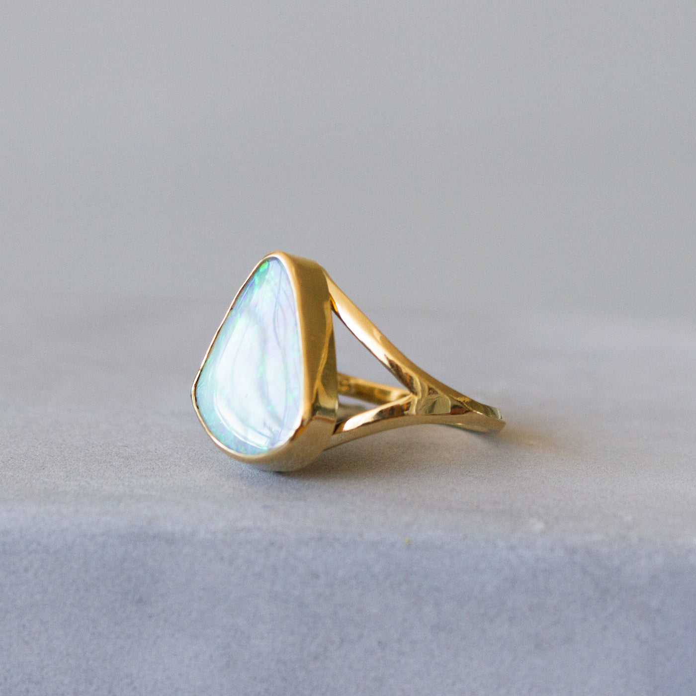 Australian Boulder Opal Gold Cleo Ring on a plain background, side angle