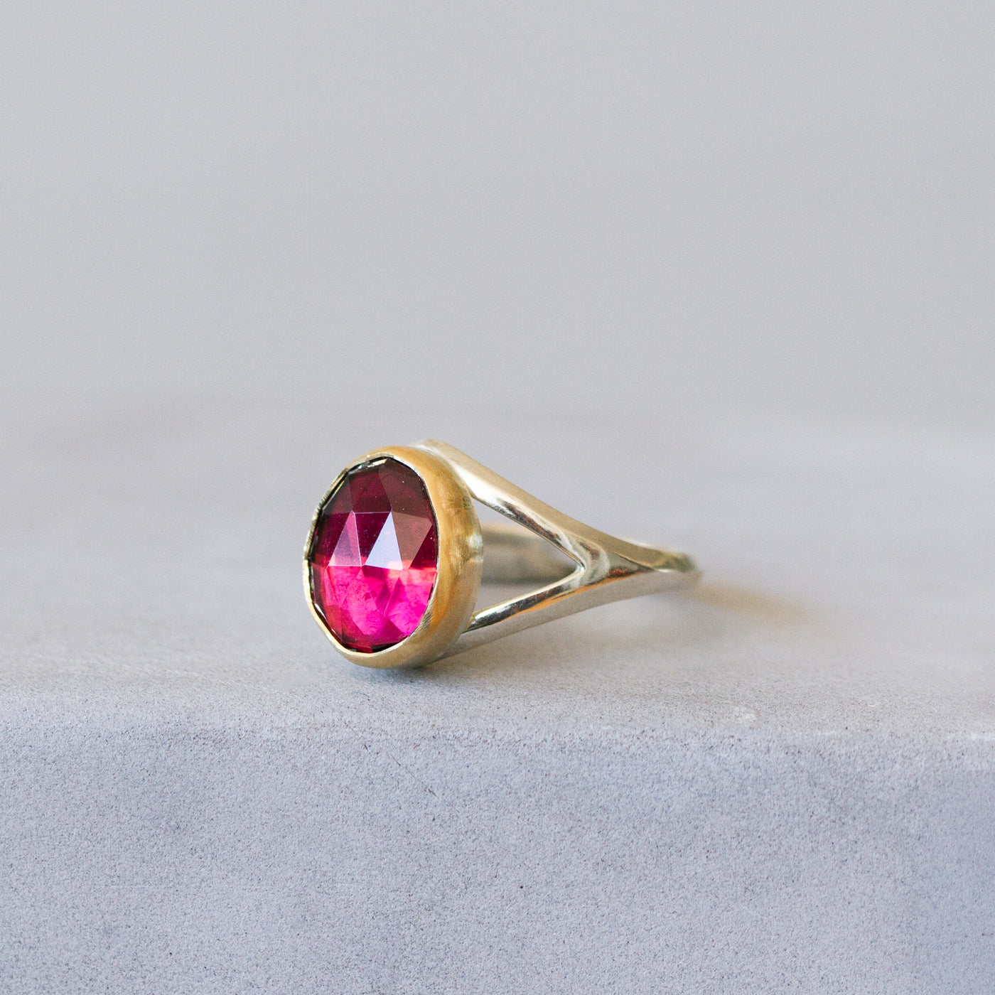 Pink Tourmaline Silver and Gold Cleo Ring on a plain background, side angle