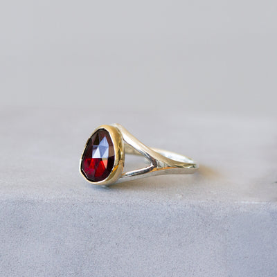 Red Tourmaline Silver and Gold Cleo Ring on a plain background, side angle